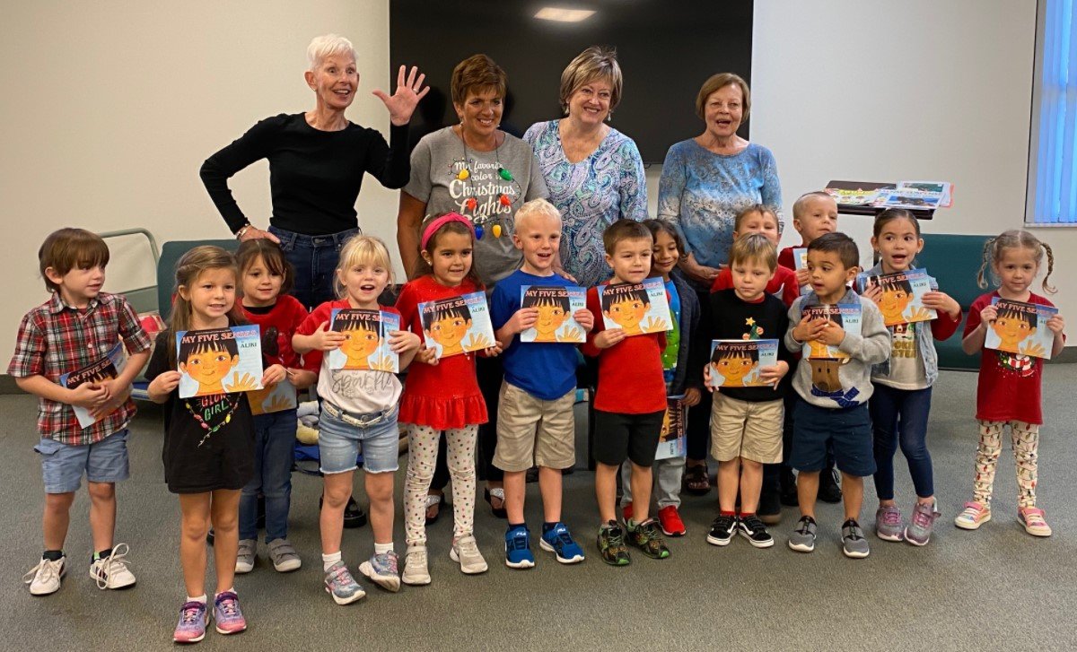Students from Turning Point Christian Academy in St. Augustine show off their copies of the book “My Five Senses” by Aliki Brandenberg during a program presented by the Early Learning Coalition of North Florida in December.